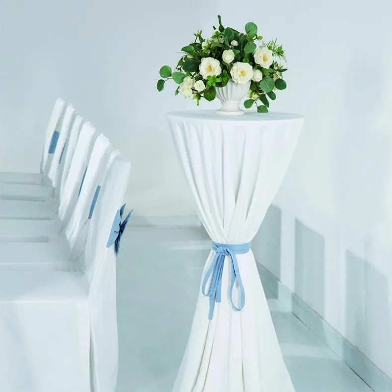 Tailored white chair and table covers prepared for an event