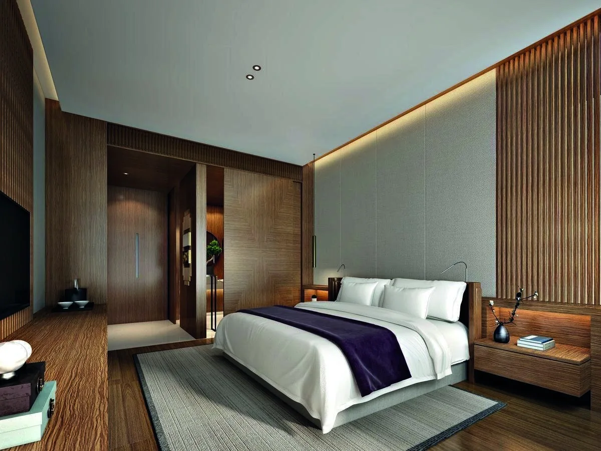 Contemporary hotel bedroom with coordinated headboard, furniture and curtains